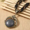 Detailed macro view of bohemian ethnic vintage necklace with large crackle stone pendant - Black