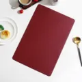 European minimalist solid color leather rectangular placemat detail view showing fine texture. - Rectangle / Red
