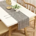 Detailed view of modern minimalist fabric table runner with textured woven design for home dining decor. - Linen Gold
