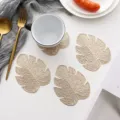 Gold monstera leaf PVC coaster set, heat-insulating table mat for coffee and tea cups. - 12x10cm / Gold