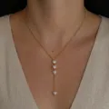 Elegant gold Y-shaped necklace with four sparkling heart zircon pendants on model. - Gold Four-Heart Rhinestone Y-Necklace(NC26Y0270)