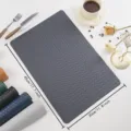 Detailed view of the dark grey woven PU leather placemat, waterproof, heat-insulating table mat. - Rectangular Woven Texture Leather Placemat / Dark Gray