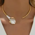 Detailed view of elegant gold-toned open choker with a white calla lily flower charm. - Calla Lily Enamel Collar