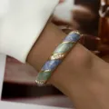 Close-up of elegant vintage blue enamel bangle with sparkling rhinestones on wrist - Blue Green Marble Rhinestone Style (BR26Y0384-4)