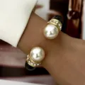 Detail view of a retro enamel bangle with pearls and sparkling rhinestones - Open Bangle with Artificial Pearl and Rhinestone (BR26Y0371-8)