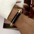Detail view of vintage black dripping oil bangle with a polished gold-plated finish. - Black Simple Rounded Style (BR26Y0371-9)