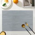 Grey PVC woven placemat for dining table, heat-resistant, waterproof, stylish kitchen accessory. - Modern Grey Lucky Bamboo