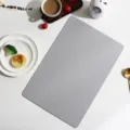 Detail view of a modern grey rectangular leather placemat with fine texture for dining table decor. - Rectangle / Gray