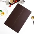 Detail shot of a brown leather placemat with grid design, waterproof heat-resistant table mat. - 45*30cm / Dark Brown