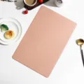 Detailed view of the elegant pink rectangular leather placemat styled with minimalist dining props. - Rectangle / Pink
