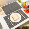 Black and white woven PVC placemat, heat-resistant table mat for modern dining decor. - Black Gold Basketweave