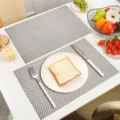 Grey PVC woven placemats heat resistant waterproof table mat for modern dining room setup - Bright Silver Basketweave