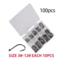 Detailed close-up view of assorted fishing hooks inside a clear plastic storage box, 100pcs. - 100 Pieces Small Pack / Black