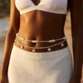 Detailed view of Bohemian multi-layer waist chain with pearls and shells on beach model. - Pearl Shell Gravel Layered Style (BJ26Y0050)