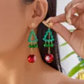 Close-up of festive Christmas tree earrings with green bells and red snowflake balls - 星型耳钉绿色闪粉圣诞树吊坠款