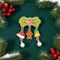 Detail view of festive Christmas enamel brooch with gingerbread man and bell charms - 姜饼人挂饰款