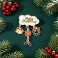 Detail view of a Christmas enamel brooch with Merry Christmas text and hanging charms - 白云圣诞铃铛款