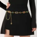 Detailed macro view of vintage gold waist chain with colorful gemstones on black dress - Colored Gemstone Tassel Style (BJ25Y0229) / Antique Gold