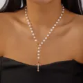 Elegant white pearl necklace featuring a colorful rhinestone cross pendant on model. - Artificial Pearl Colorful Rhinestone Gold Cross Necklace (NC25Y1191)