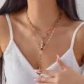 Gold layered necklace with colorful rhinestones and cross pendants worn by model. - 金色三层彩色水钻十字架款(NC25Y1180金色)