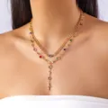 Double-layered gold cross necklace featuring colorful gemstones shown on model - 金色双层粗链彩色水钻十字架款(NC25Y0957)