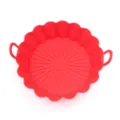 Detailed view of the red silicone air fryer pot liner showing textured bottom and handles. - Red