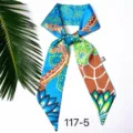 Blauwe zijden sjaal met giraffenprint, ideaal als handtaslint of haaraccessoire. - Giraffe op blauwe achtergrond