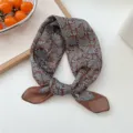 Detailed close-up view of the brown cotton blend small square scarf featuring elegant blue leaf pattern. - Brown & Blue Frosted Flowers
