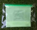 Food-grade silicone food storage bag with capacity markings and green slider seal detail view. - Food Storage Bag 2500ml / Green