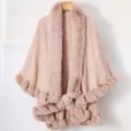 Detail view of a pink knitted shawl featuring a thick faux fur collar and soft fur trim - Tops / Pink