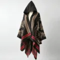 Detailed close-up of ethnic pattern knit hooded shawl wrap with vibrant red accents - Black Starburst Floral Poncho