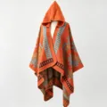 Detailed view of an orange bohemian knit hooded poncho cape with geometric patterns. - Orange and Green Starburst Floral Poncho