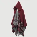 Side view of a burgundy knitted hooded cloak with intricate grey jacquard patterns. - Tops / Burgundy