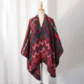 Detailed view of a men's winter knitted shawl poncho with geometric ethnic patterns - Red and Green