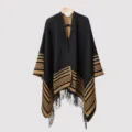 Detailed view of the striped knit poncho featuring black and tan fringe tassels. - 135*150CM / Black Camel
