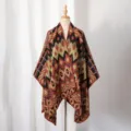 Detailed close-up of men's knitted poncho featuring a vintage geometric tribal pattern. - Caramel color