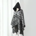 Detailed view of women's hooded knit poncho featuring bold grey geometric patterns - One Size / Cloak Colorful Geometric Black & Grey