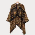 Vollansicht eines Vintage-Jacquard-Ponchos mit geometrischen Mustern am Kleiderbügel. - Camel