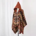 Close-up detail of women's hooded knitted poncho featuring ethnic geometric tribal patterns - One Size / Cloak Colorful Geometric Caramel