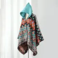 Women's hooded knitted poncho with vibrant geometric pattern in orange and teal blue - One Size / Colorful Geometric Poncho in Green-Orange