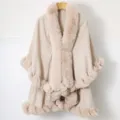 Close-up of elegant apricot knitted shawl featuring a luxurious faux fur collar and trim - Tops / Beige