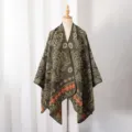 Vintage paisley patterned knitted poncho shawl displayed on a neutral dress form stand - Small Paisley / Slit Scarf / Green Orange