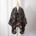 Detailed view of bohemian knitted poncho with ethnic floral and paisley patterns - Small Paisley / Slit Scarf / Black Camel