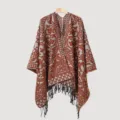 Detail shot of men's knitted winter poncho featuring ethnic patterns and fringe tassels - Caramel Split Scarf