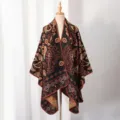 Front view of a knitted paisley shawl on a mannequin showing detailed patterns and textures - Small Paisley / Slit Scarf / Caramel color
