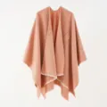 Detailed view of a minimalist solid color peach knit shawl with soft fringed edges - 130*160cm / Orange