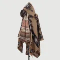 Detailed view of a women's hooded knitted poncho featuring geometric ethnic patterns - Tribal Cipher Poncho - Camel