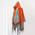 Orange and teal striped hooded knit poncho shawl with fringes displayed on mannequin - 135x150cm / Orange