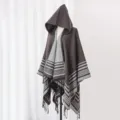 Detailed view of a brown hooded knit shawl featuring a striped pattern and fringe tassels. - 135x150cm / Gray