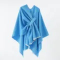 Close-up detail of a bright blue knitted poncho featuring a unique front knot design - 130*160cm / Blue
